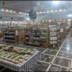 A large grocery store with a variety of food items and a large display of wine bottles.