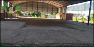 A large open building with a dirt floor.