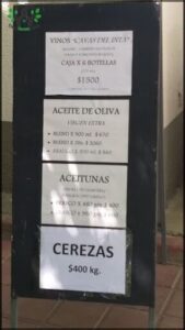 A sign for a bar with a list of drinks and their prices.