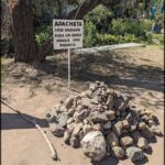 A sign in front of a pile of rocks reads "Apaecheta."