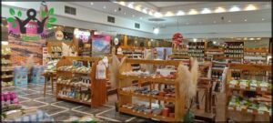 A store with a variety of items for sale, including a large selection of bottles.