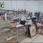 A store with a variety of items, including a poster with a CD on it.