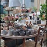 A table full of various cups and bowls.