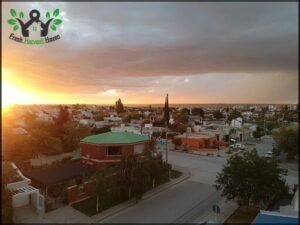 a view of a city with a church and a sunset