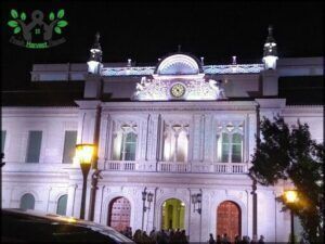 arafed building with a clock on the front of it at night
