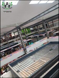 arafed conveyor belt in a store with lots of shelves