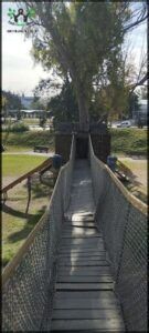 araffe bridge over a grassy area with benches and trees