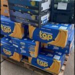 boxes of bananas are stacked on a pallet outside a store