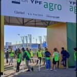 people are walking around a large expo area with a sign