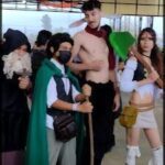 several people dressed up in costumes and holding umbrellas in a building