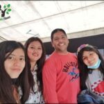 there are four people posing for a picture together in a tent
