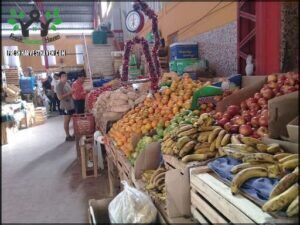 there are many fruits and vegetables on display in a market