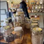 there are many jars of food on a table in a store