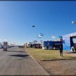 there are many people walking around a tent at a fair