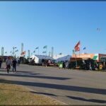 there are many people walking down the street at a fair