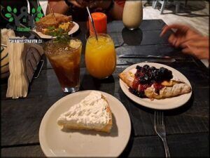there are two plates of food on the table with drinks