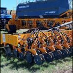 there are two tractors that are parked in the field