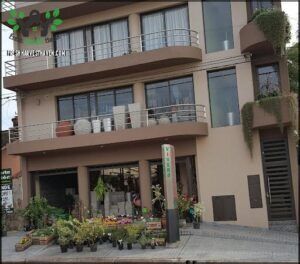 there is a building with a balcony and a balcony on the second floor