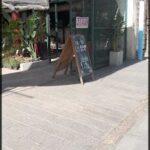 there is a large green sign on the side of a building