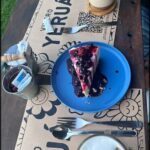 there is a piece of pie on a blue plate on a table