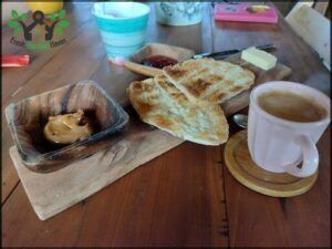 there is a plate of food and a cup of coffee on a table
