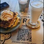 there is a plate of food on a table with a glass of milk