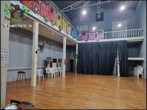 there is a room with a stage and a black curtain