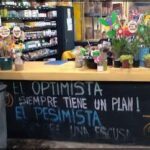there is a sign that says optimistaa on the counter