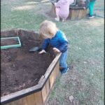 there is a small child that is digging in the dirt