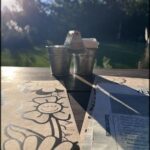 there is a table with a menu and a cup of coffee