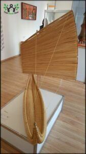 there is a wicker boat on display in a museum