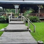 there is a wooden walkway leading to a small cabin