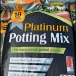 A bag of potting mix is displayed for sale.
