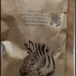 A bag of zebra stone is shown with a picture of a zebra on it.