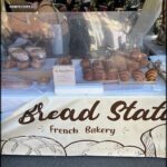 A bakery display with a sign that reads "Bread Station."