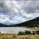 A beautiful mountain lake with a cloudy sky above.
