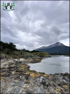 A beautiful mountain range is visible in the distance, with a body of water in the foreground.