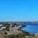 A beautiful view of a city with a large body of water in the foreground.