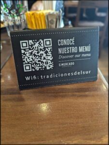 A black and white menu card with a QR code on it.