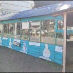 A blue building with a snowman painted on the side.