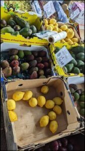 A box of lemons sits on a table, ready to be sold.