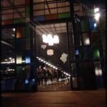 A brightly lit restaurant with a colorful glass door.