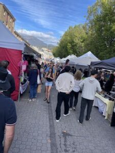 A busy street filled with people walking and shopping.