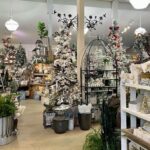 A Christmas tree shop with a variety of trees and decorations.