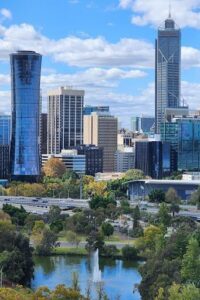 A city skyline with a large building and a bridge.