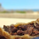 A close-up of a delicious meat pie, ready to be enjoyed.