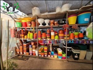 A colorful display of pots and bowls for sale.