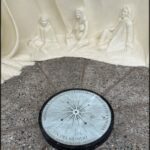 A compass with a sun in the middle is on display.