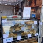 A display of various pies and pastries, including a caramel sea salt pie, is available for purchase at this location.