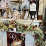 A fireplace with a holiday decoration and a sign that says "Happy Holidays".